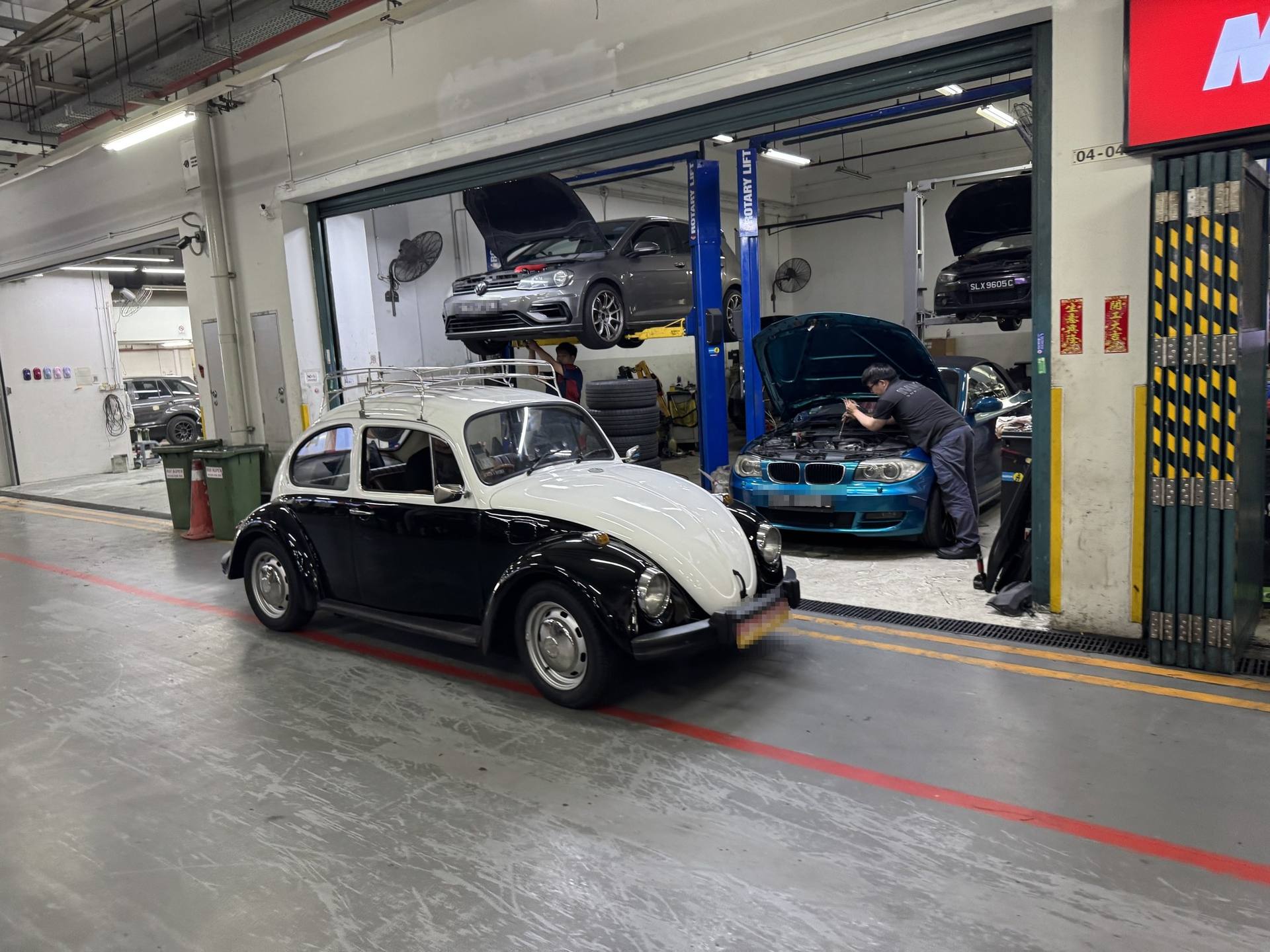 Classic black and white Volkswagen Beetle at the MK9 workshop