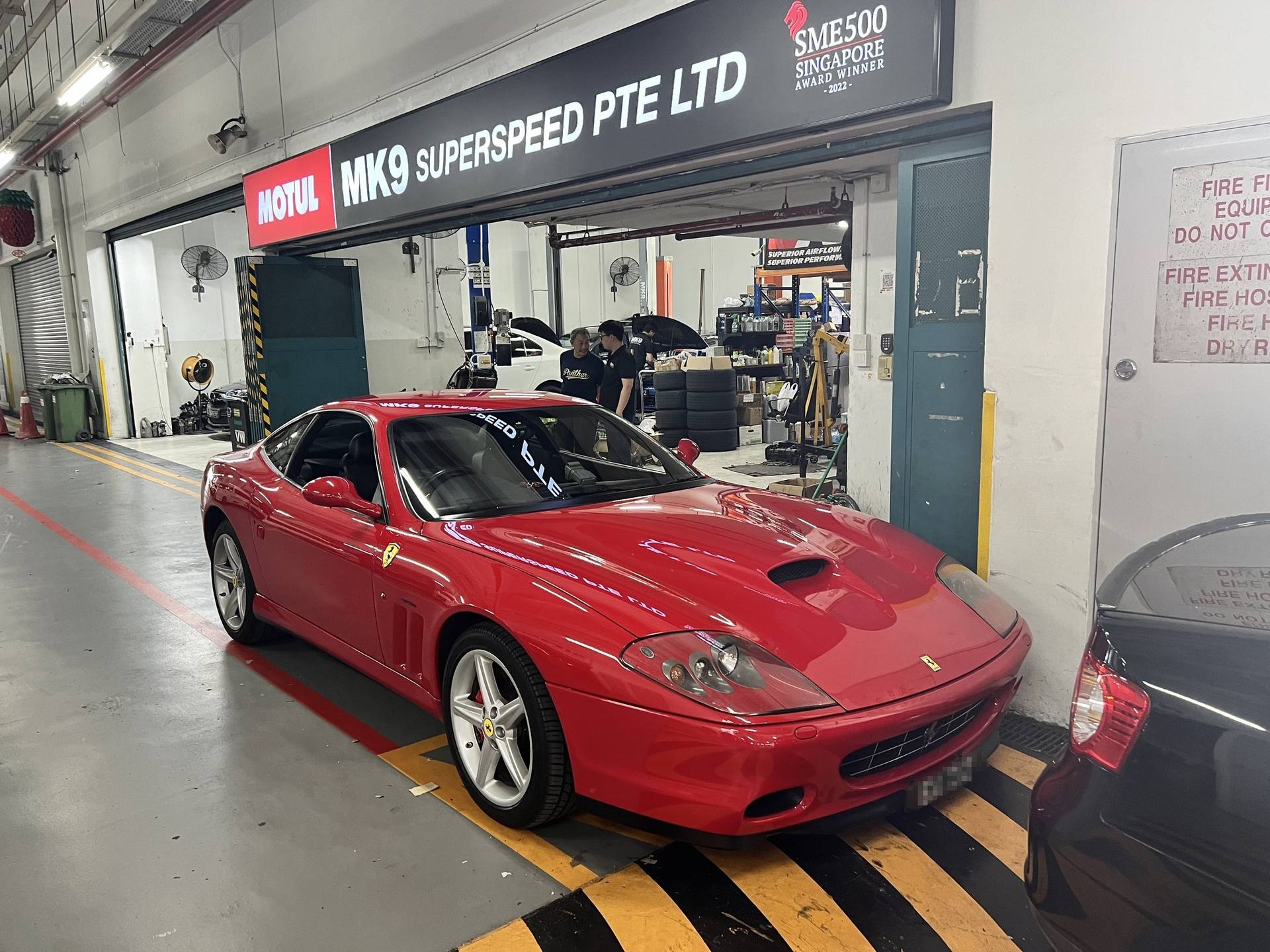 Red Ferrari 575M outside the MK9 Superspeed workshop