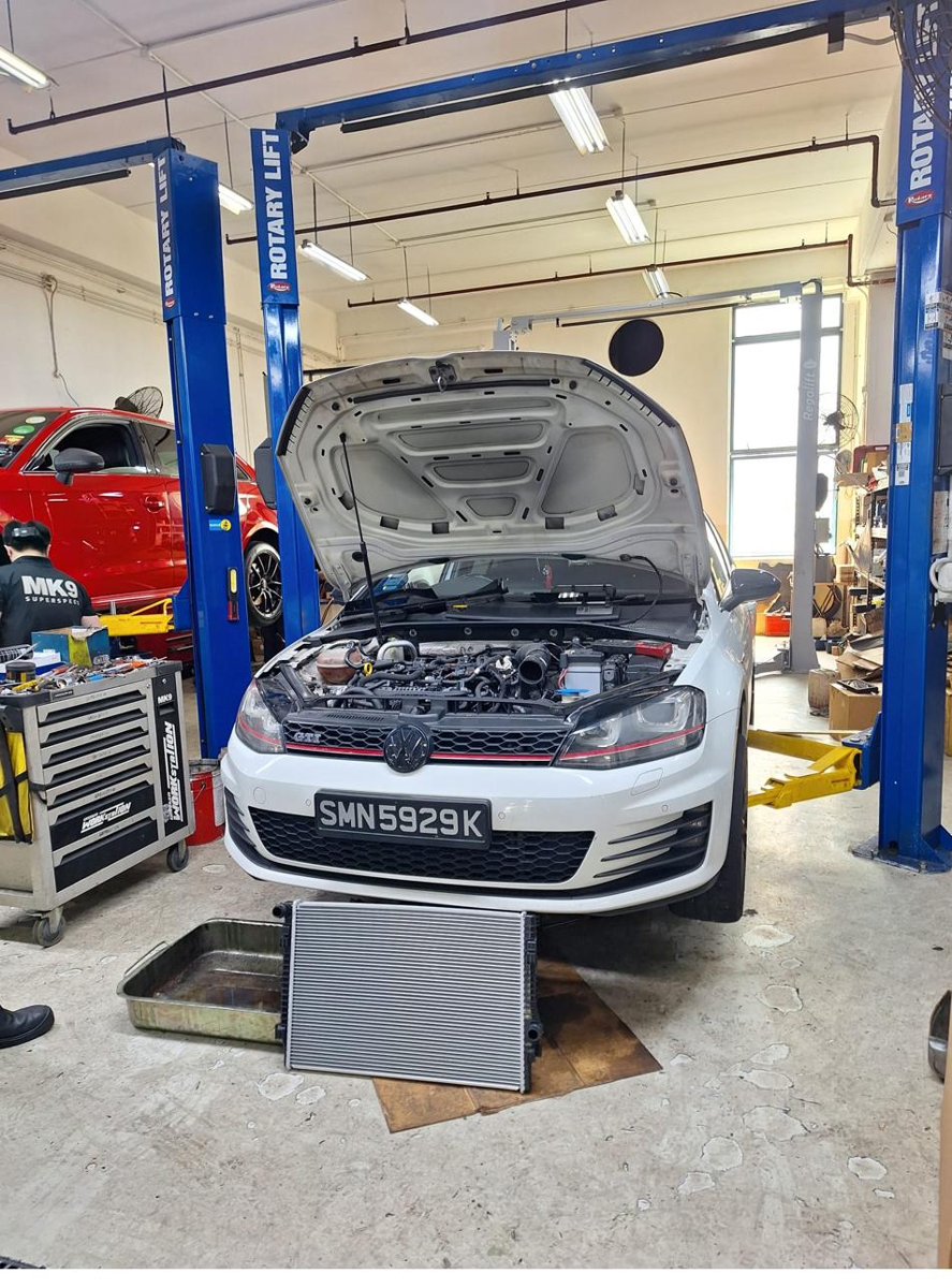 White Volkswagen Passat wagon raised on a lift